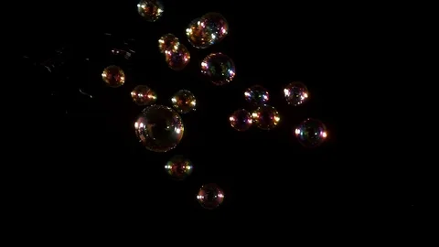 Studio shot bubbles from left frame against black Stock Footage 77134551