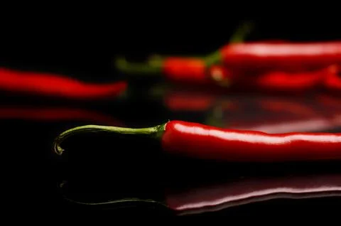Studio shot of chilli peppers on black Stock Photos