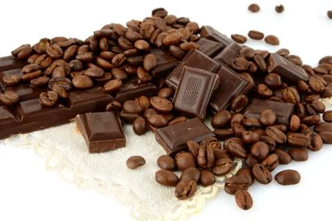 Studio shot of chocolates and beans of coffee isolated on white background Stock Photos