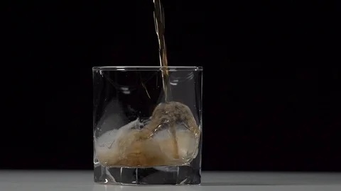 Studio shot of Cola pouring into transparent glass on white table. Stock Footage 126144915