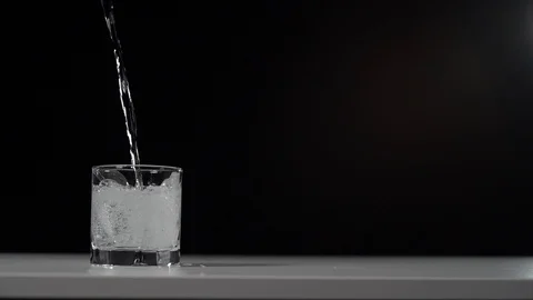 Studio shot of Cola pouring into transparent glass on white table. Stock Footage 126145010