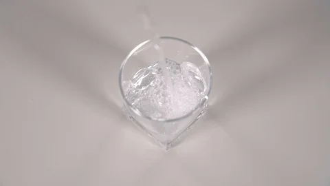 Studio shot of Cola pouring into transparent glass on white table. Stock Footage 126145637