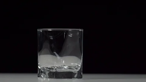 Studio shot of Cola pouring into transparent glass on white table. Stock Footage 126319178