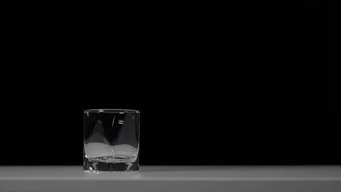 Studio shot of Cola pouring into transparent glass on white table. Video stock 126319678
