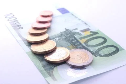 Studio shot of complete set of euro coins on 100 euro bank note. symbol for e Stock Photos