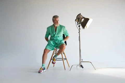 Studio shot of cool gray haired mature man wearing stylish outfit with colorful Stock Photos