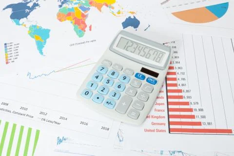 Studio shot of a data charts with calculator over it Stock Photos