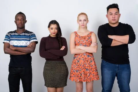 Studio shot of diverse group of multi ethnic friends with arms c Stock Photos