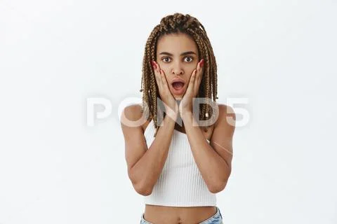 Studio shot of emotive shocked and stunned young dark-skinned cool ...