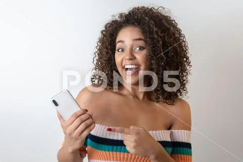 Studio shot of entertained cute happy african american girl with afro hairsty Stock Photos