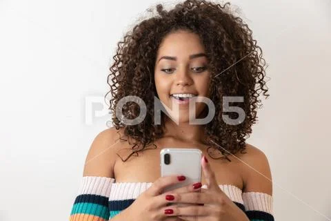 Studio shot of entertained cute happy african american girl with afro hairsty Stock Photos