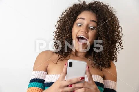 Studio shot of entertained cute happy african american girl with afro hairsty Stock Photos