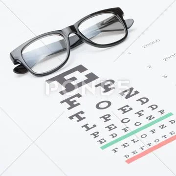 Studio Shot Of Eyesight Test Chart With Glasses Over It
