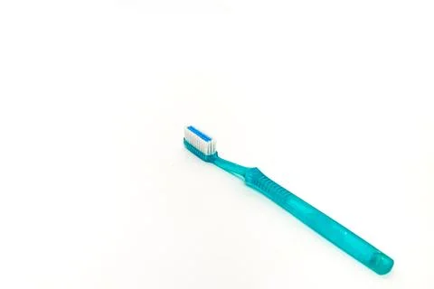 Studio shot featuring a teal toothbrush against a clean white background,pr.. Foto stock