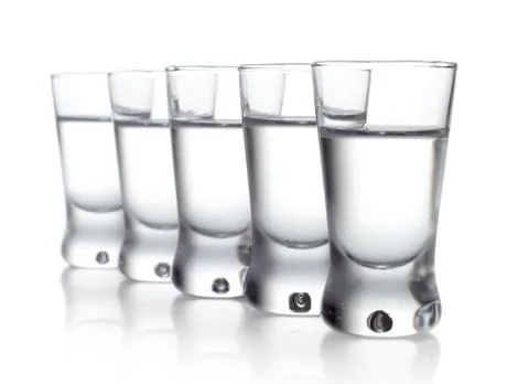 Studio shot of five glasses of vodka isolated on white Stock Photos