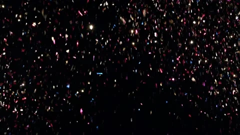 Studio shot glossy confetti falling against black background Stock Footage 142393866