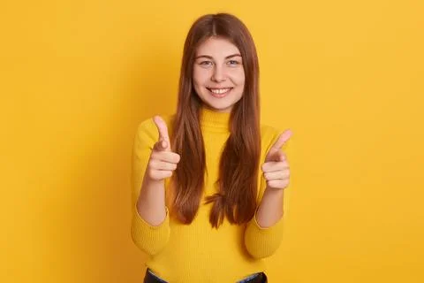 Studio shot of good looking young caucasian woman pointing to camera with h.. Stock Photos