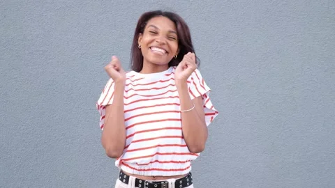 The studio shot a hyperactive African ethnic woman rejoicing in the praise Stock Footage 203831438