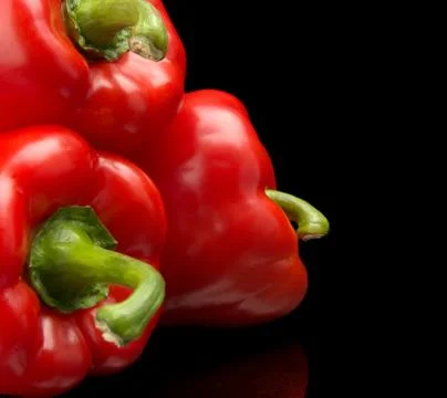 Studio shot macro view of red bell peppers in the corner isolated on black Stock Photos