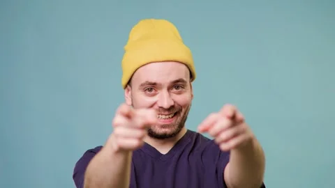 A studio shot of a male with a charming expression, pointing his finger directly Stock Footage 304808205