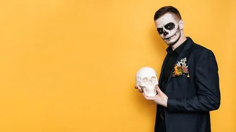 Studio shot of a man on a bright background in a costume of evil spirits at a Stock Photos