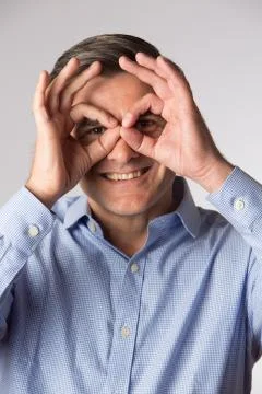 Studio Shot Of Man Making Spectacle Shape With His Hands Foto stock