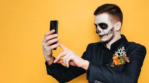 A studio shot of a man taking a selfie in a costume of evil spirits at a Stock Photos
