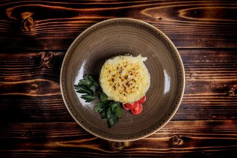 Studio shot of mashed potatoes topped with cheese garnish, placed on a plate  Stock Photos