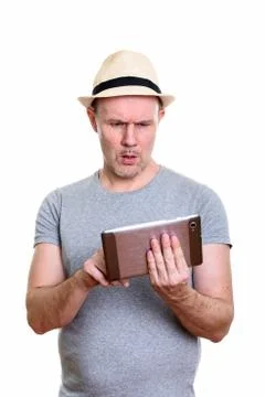 Studio shot of mature man using digital tablet looking confused Foto stock