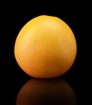 Studio shot of one grapefruit isolated on black background Stock Photos
