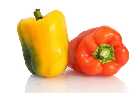 Studio shot of one yellow pepper and one red pepper on white background Stock Photos