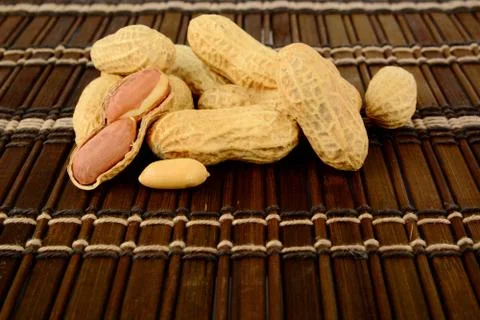 Studio shot of peanuts on brown mat Stock Photos