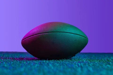 Studio shot of professional ball for american football game isolated over purple Stock Photos