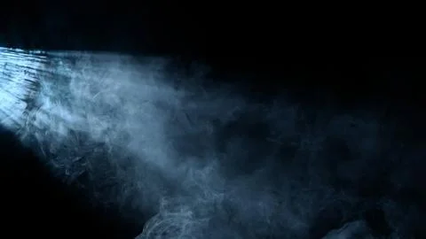 Studio shot of projector haze effect isolated on black background. Cold white Stock Photos