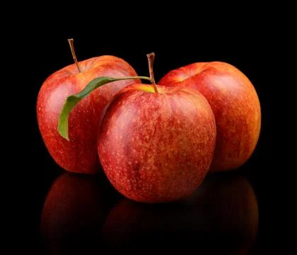 Studio shot of red apples with leaf isolated on black background Stock Photos