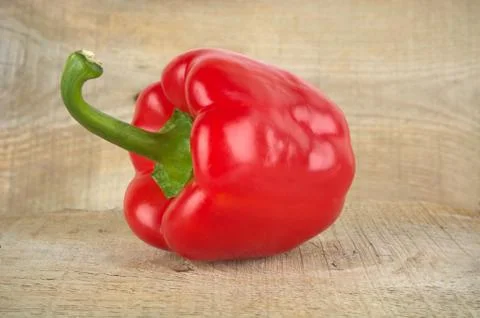 Studio shot of red bell pepper isolated on wooden table Stock Photos