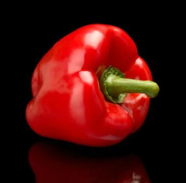 Studio shot of red bell pepper isolated on black background Stock Photos