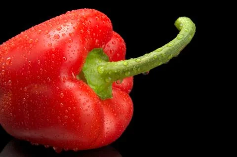 Studio shot of red bell pepper isolated on black background Stock Photos
