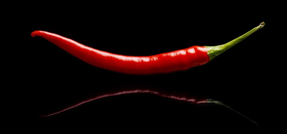 Studio shot of red pepper, chilli isolated on black background Stock Photos