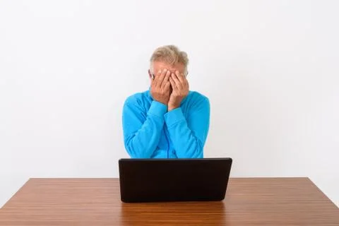 Studio shot of senior bearded man covering face with both hands Stock Photos