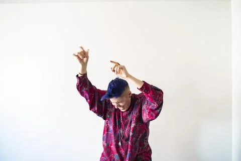 Studio shot of smiling non-binary person dancing Stock Photos