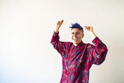 Studio shot of smiling non-binary person dancing Stock Photos