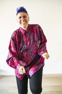 Studio shot of smiling non-binary person dancing Stock Photos