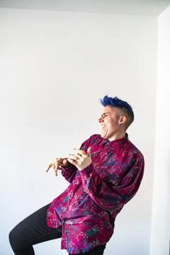 Studio shot of smiling non-binary person dancing Stock Photos