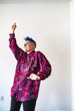 Studio shot of smiling non-binary person dancing Stock Photos