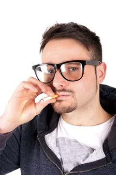 Studio shot of a smoking boy Stock Photos