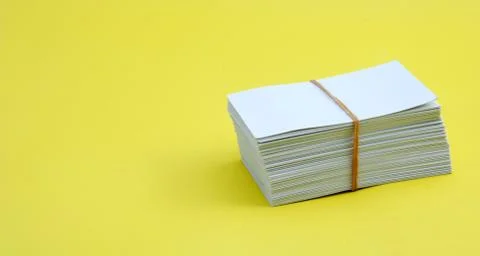 Studio shot of stack of envelopes on yellow background Foto stock
