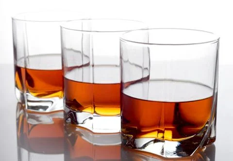 Studio shot of three glasses of whiskey Stock Photos