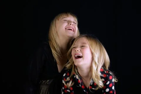 Studio shot of two Sisters (12-13, 16-17) laughing Stock Photos