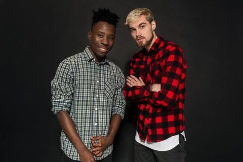 Studio shot of two stylish young men having fun. Handsome bearded hipster in a Stock Photos